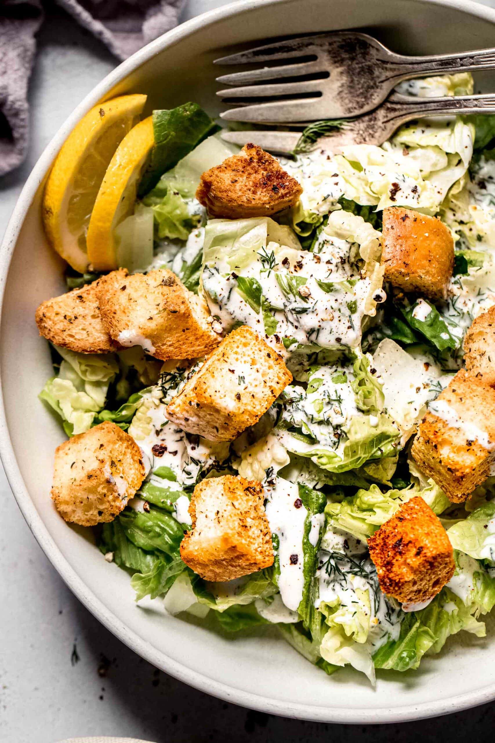 Green salad with croutons drizzled with greek yogurt salad dressing.
