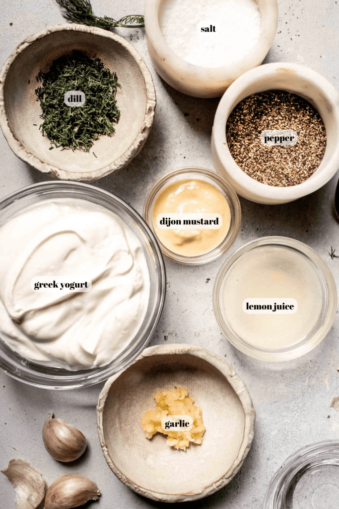 Ingredients for greek yogurt dressing labeled on counter. 