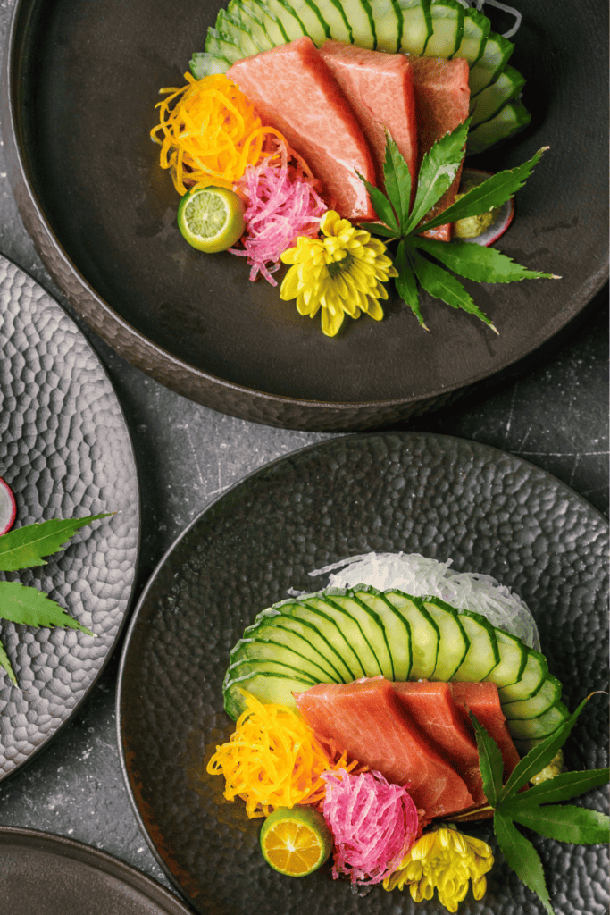 Sashimi slices arranged on plates. 