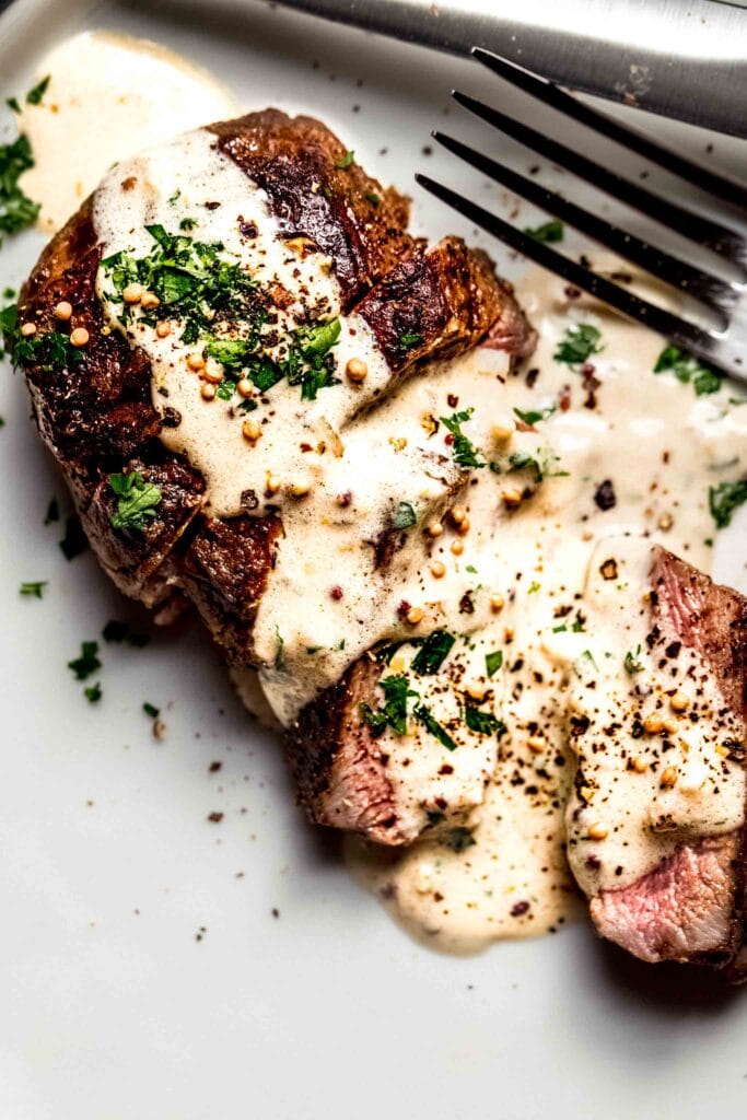 Steak drizzled with creamy mustard sauce.