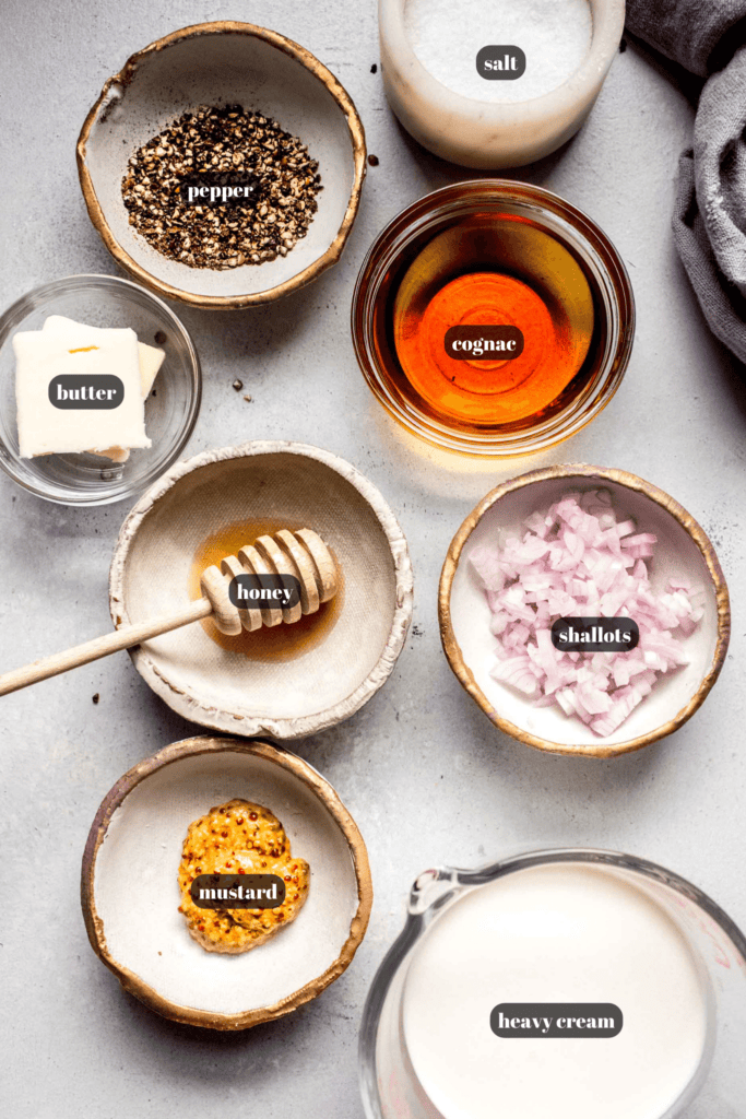 Ingredients for mustard sauce for steak labeled on counter.