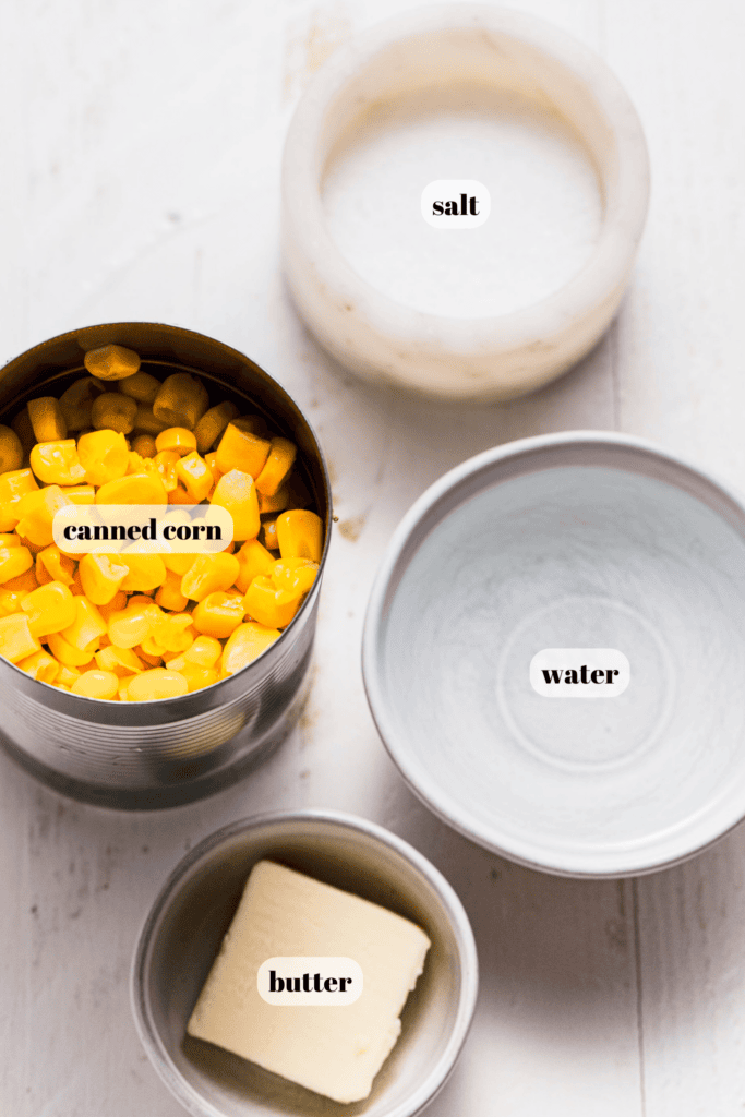 Ingredients for canned corn labeled on counter. 