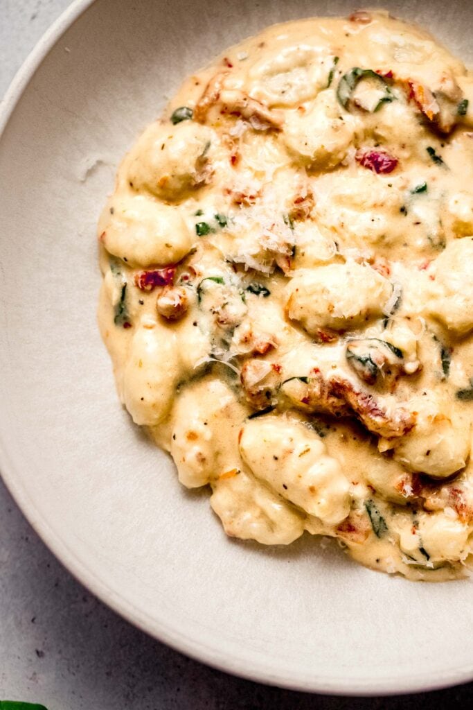 Gnocchi in serving bowl with sun dried tomatoes. 