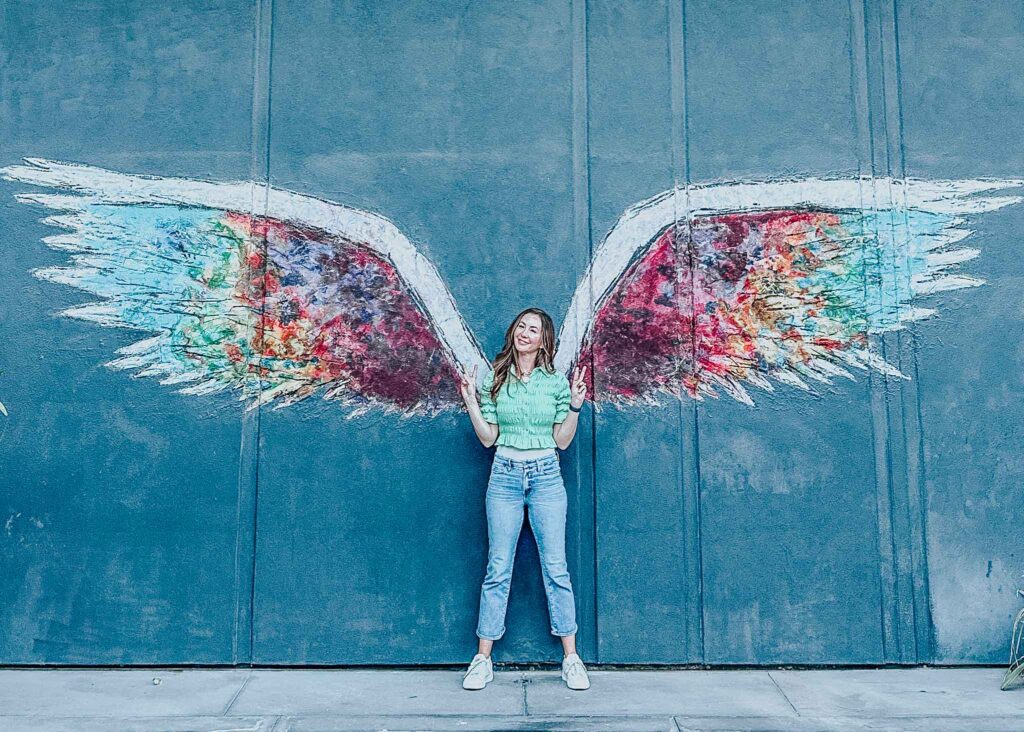 Erin in front of wings.