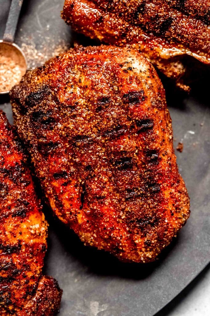 Grilled pork chops that have been coated in dry rub. 