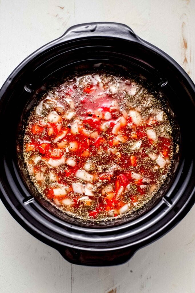 Broth added to slow cooker liner.