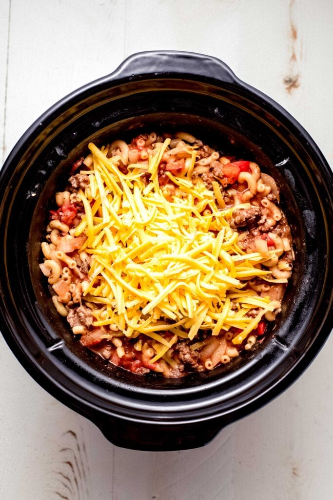 Cheese added to slow cooker goulash.