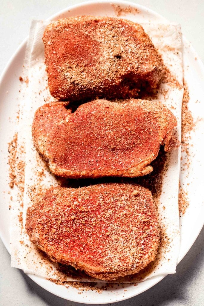 Pork chops sprinkled with dry rub mixture.