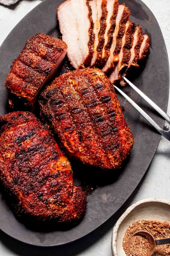 Sliced smoked pork chops on plate.