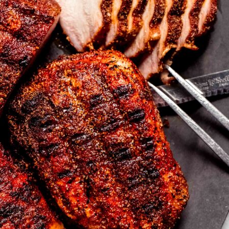 Sliced smoked pork chops on plate.