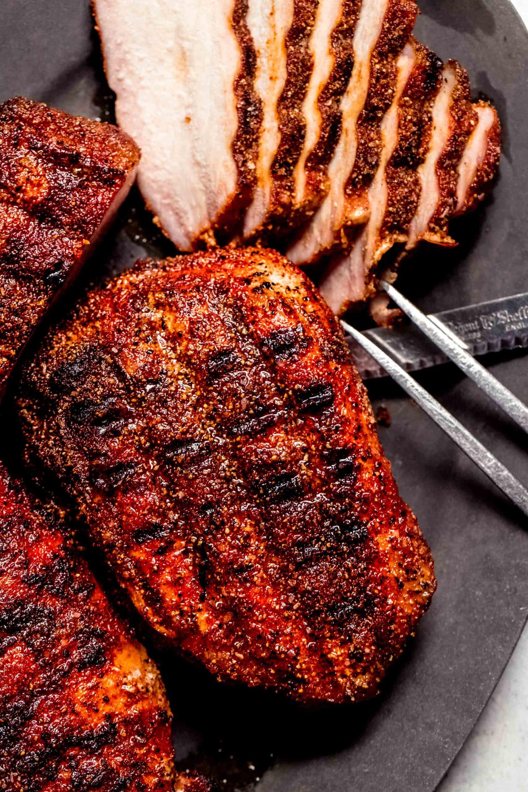 Sliced smoked pork chops on plate.