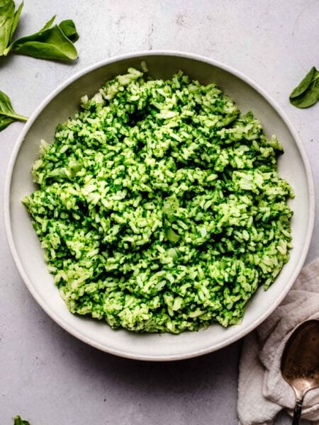 Spinach rice in white serving bowl.