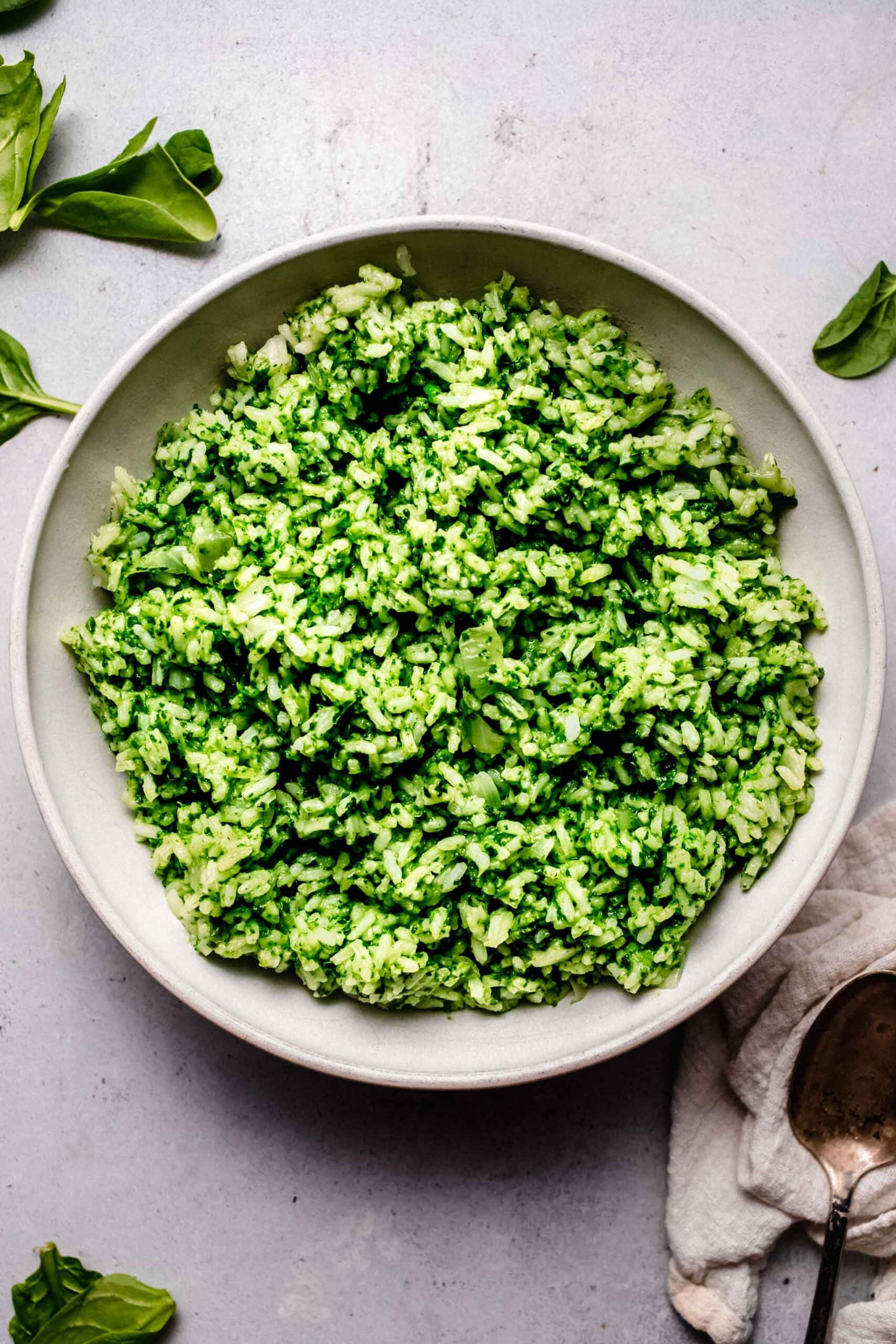 Spinach rice in white serving bowl.