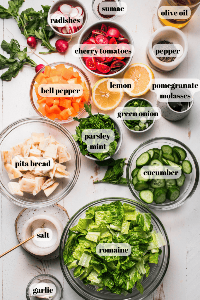 Ingredients for fattoush salad labeled on counter.
