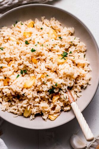Close up of garlic rice in serving bowl.