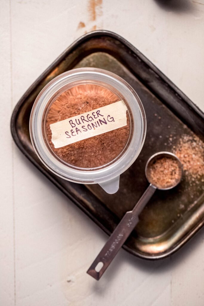 Burger seasoning labeled in small glass jar.