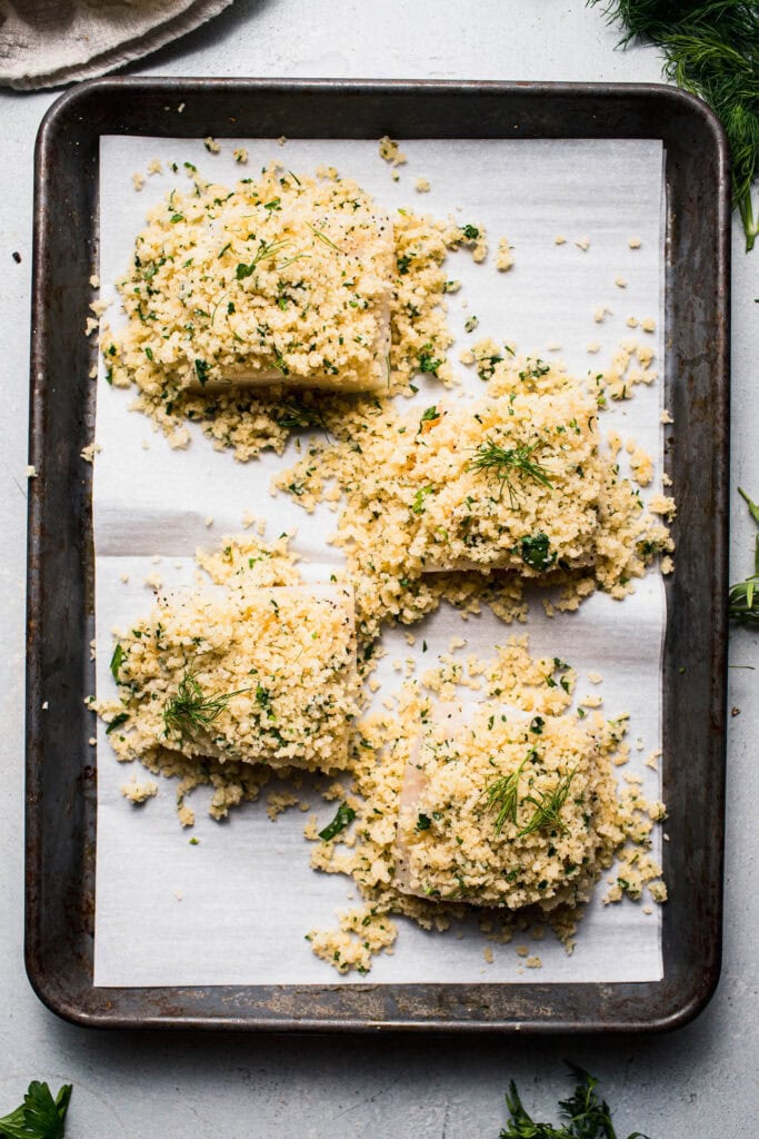 Cod filets coated with panko before baking. 