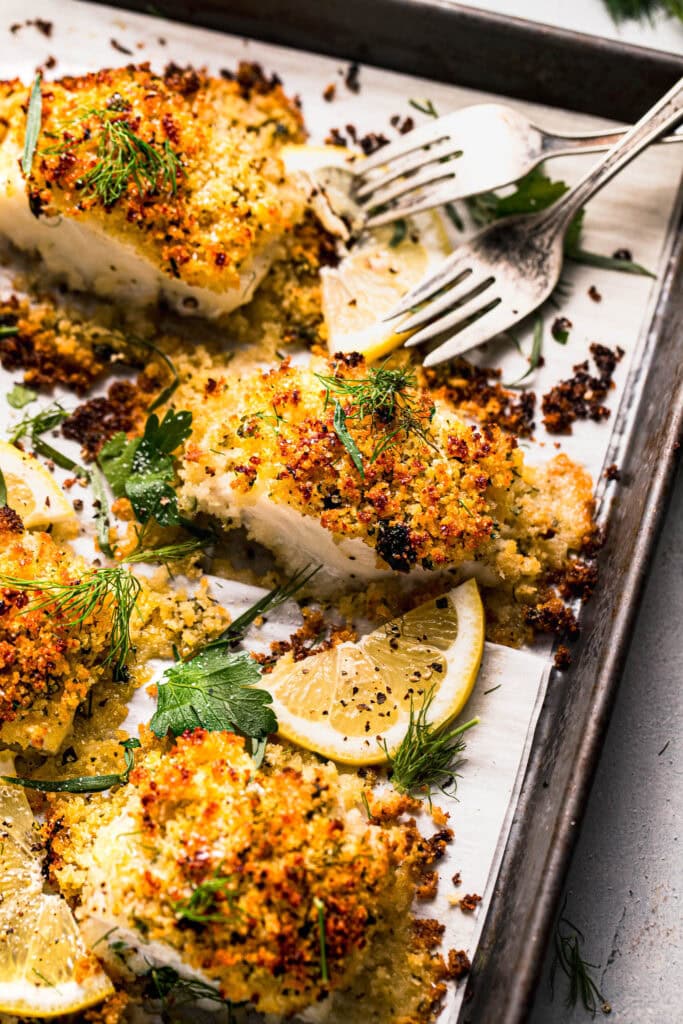 Baked panko cod pieces on baking sheet. 