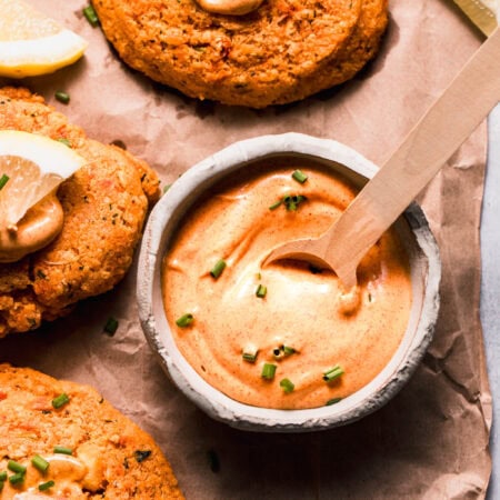 Bowl of lobster cake sauce with spoon.