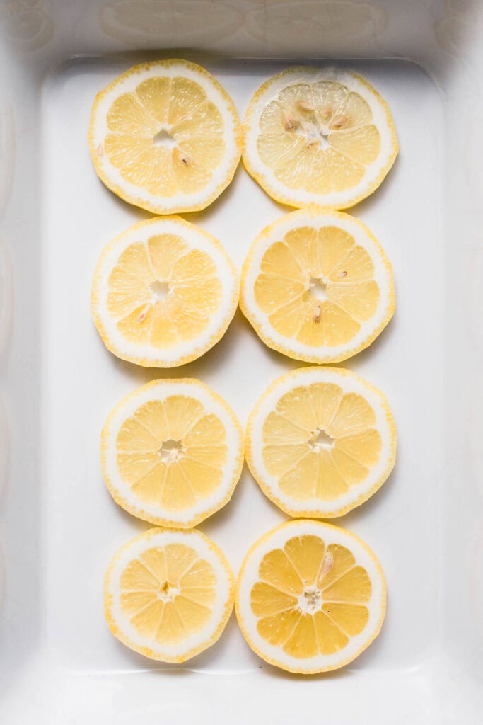 Lemons arranged in baking dish. 