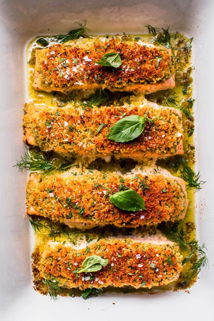 Finished baked pesto salmon in baking dish. 