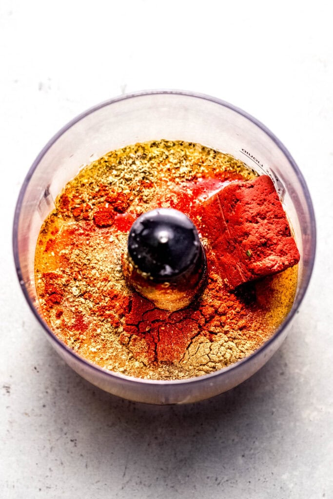 Achiote chicken marinade ingredients in food processor before blending.