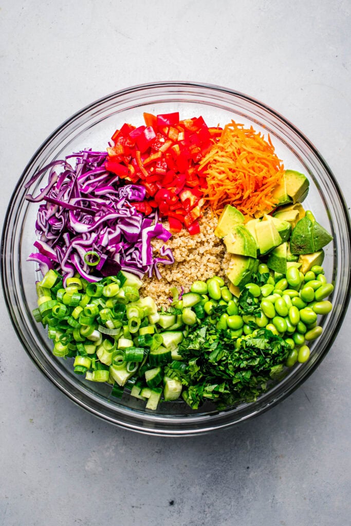 Ingredients for asian quinoa salad in bowl before being tossed together.