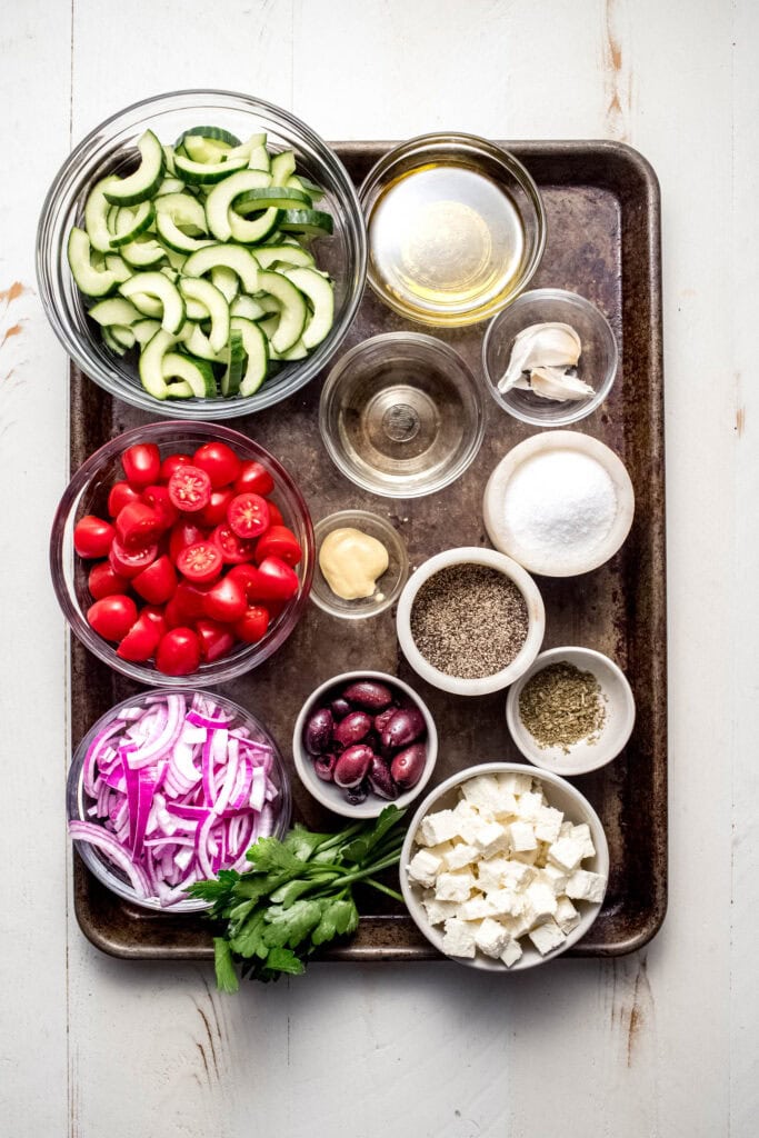 Ingredients for greek tomato salad on counter.