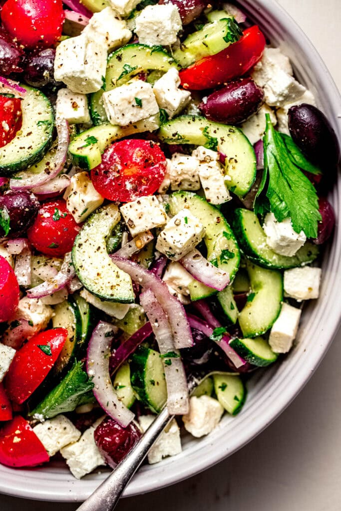 Overhead close up of greek tomato cucumber salad ready to serve.