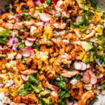 Overhead close up of assembled elote salad in bowl.