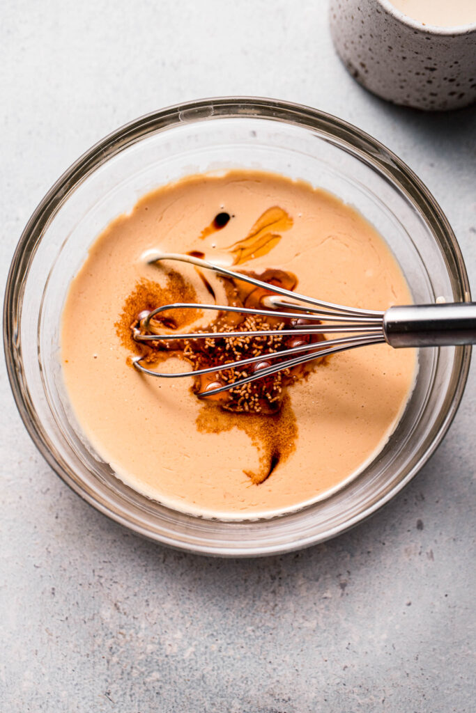 Sesame sauce ingredients in small bowl with whisk.