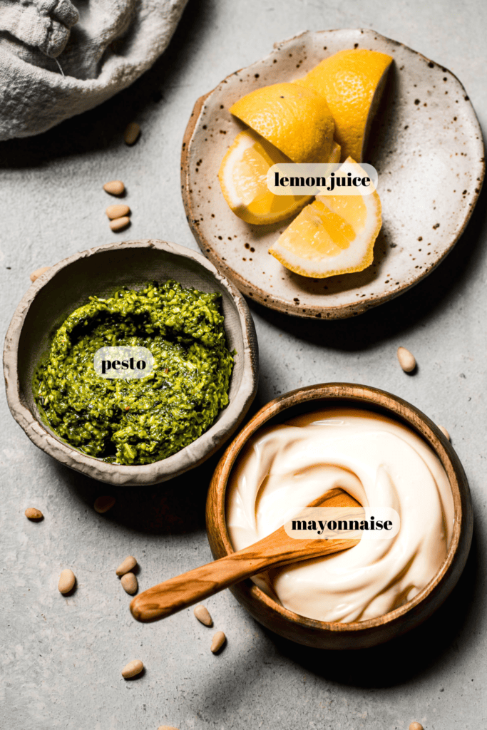 Ingredients for pesto mayo labeled on counter.