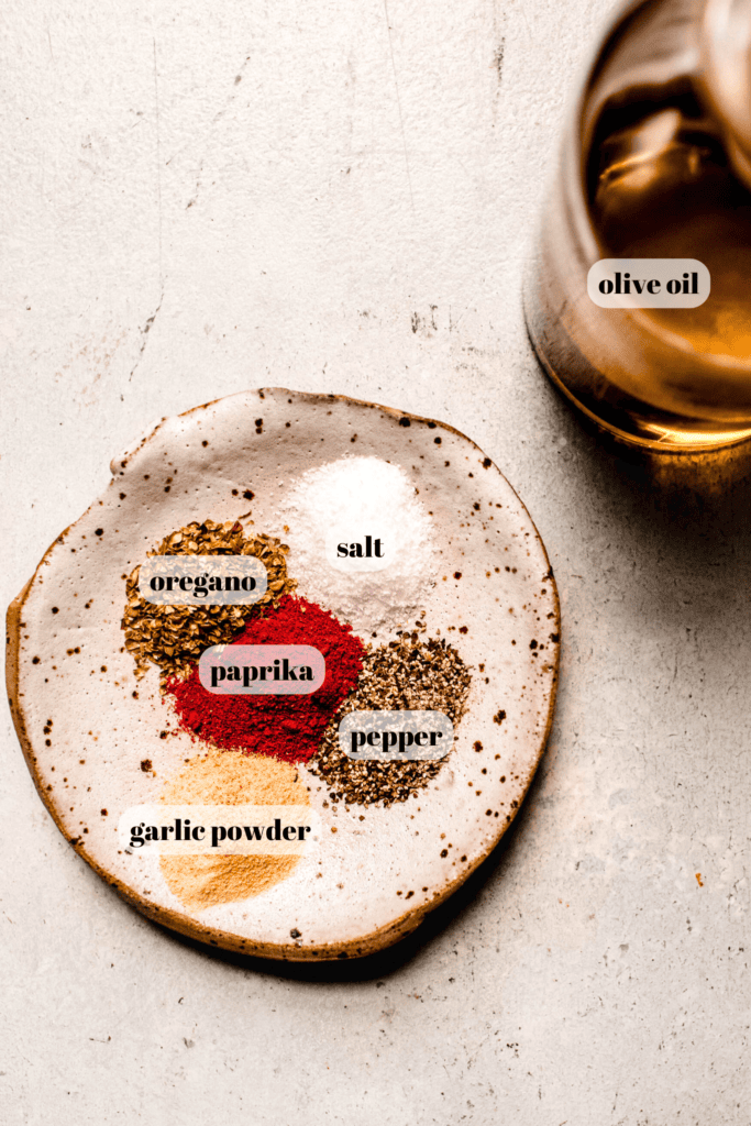 Spices for air fryer chicken bites labeled on counter. 