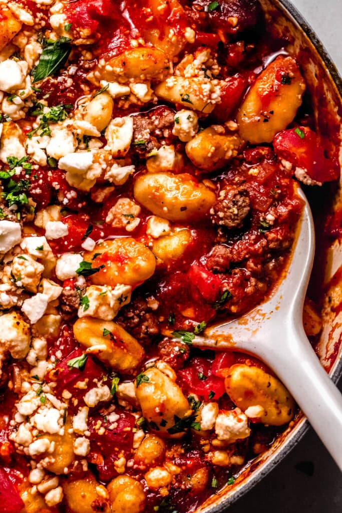 Close up of serving spoon in lamb gnocchi.