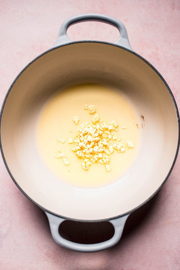 Garlic being sauteed in pot.