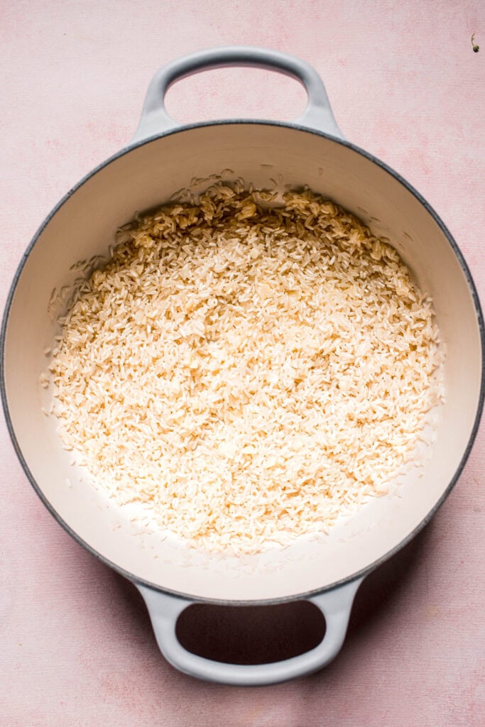 Rice being toasted in pot.