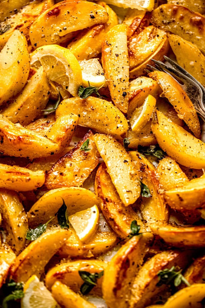 Roasted greek potatoes on baking sheet.