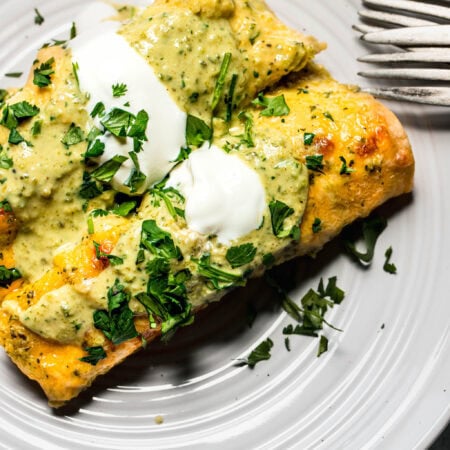 Two poblano enchiladas on serving plate.