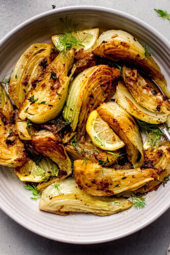 Finished caramelized fennel in white serving bowl.