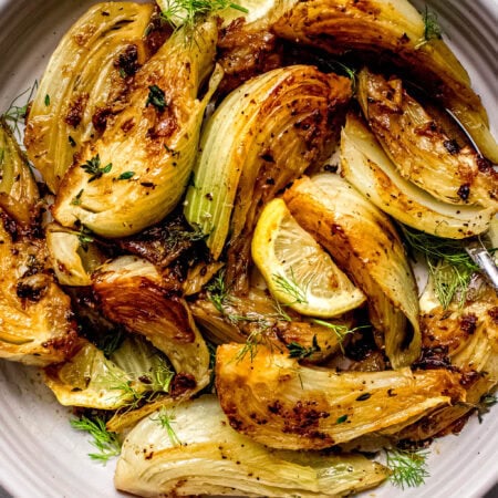 Finished caramelized fennel in white serving bowl.