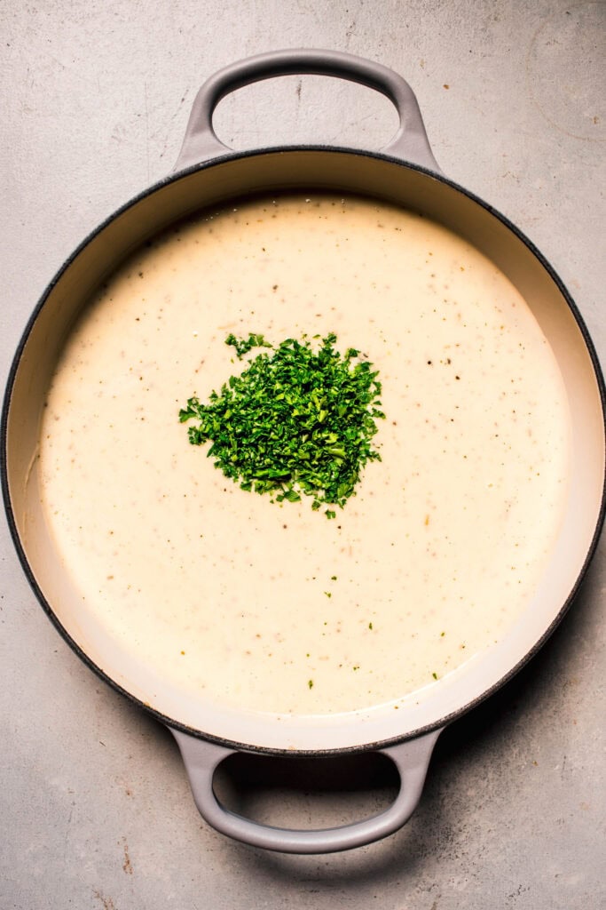 Parsley added to parmesan cream sauce.
