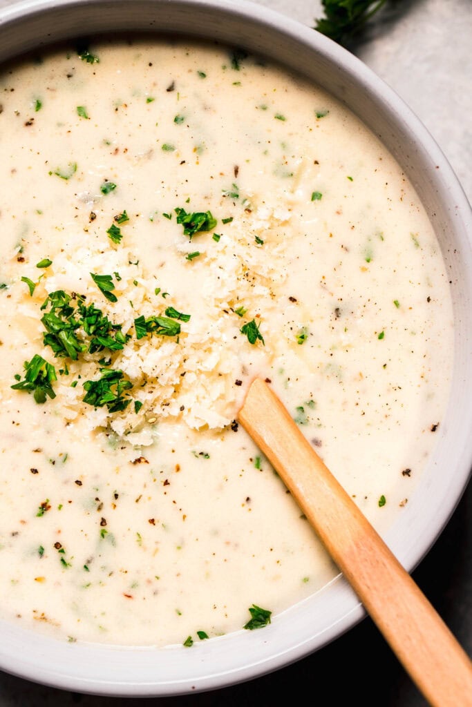Overhead close up of parmesan cream sauce in bowl.