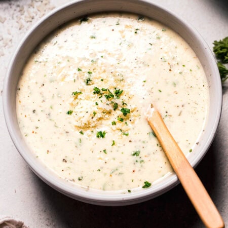Side view of parmesan cream sauce in serving bowl.