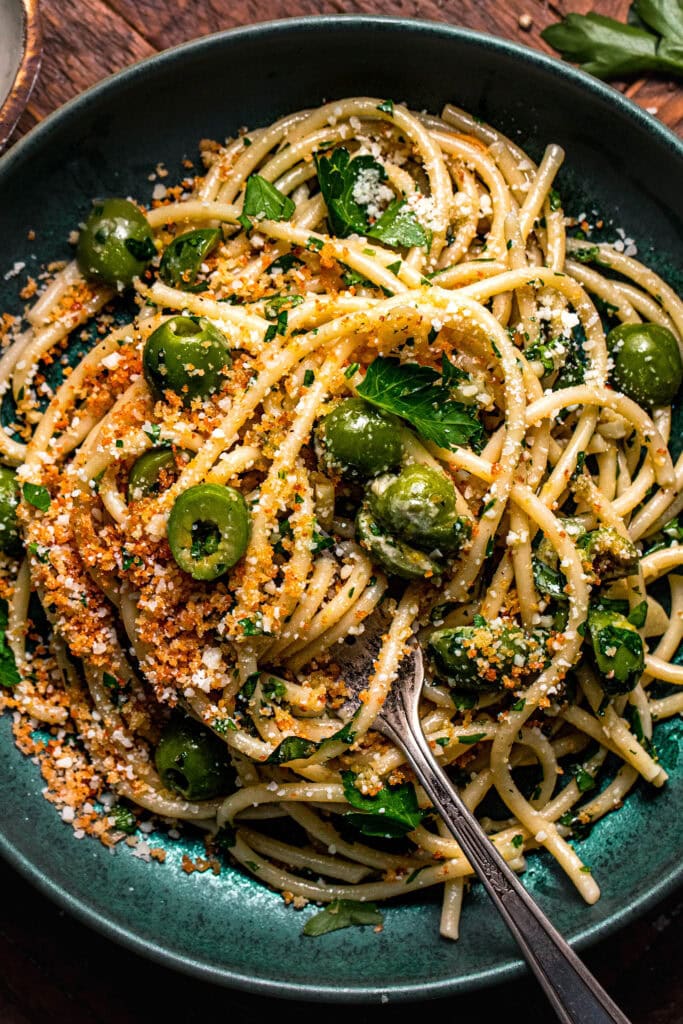 Extreme close up of olive pasta in serving bowl.