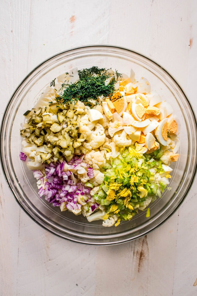 Ingredients for cauliflower potato salad in bowl before mixing.