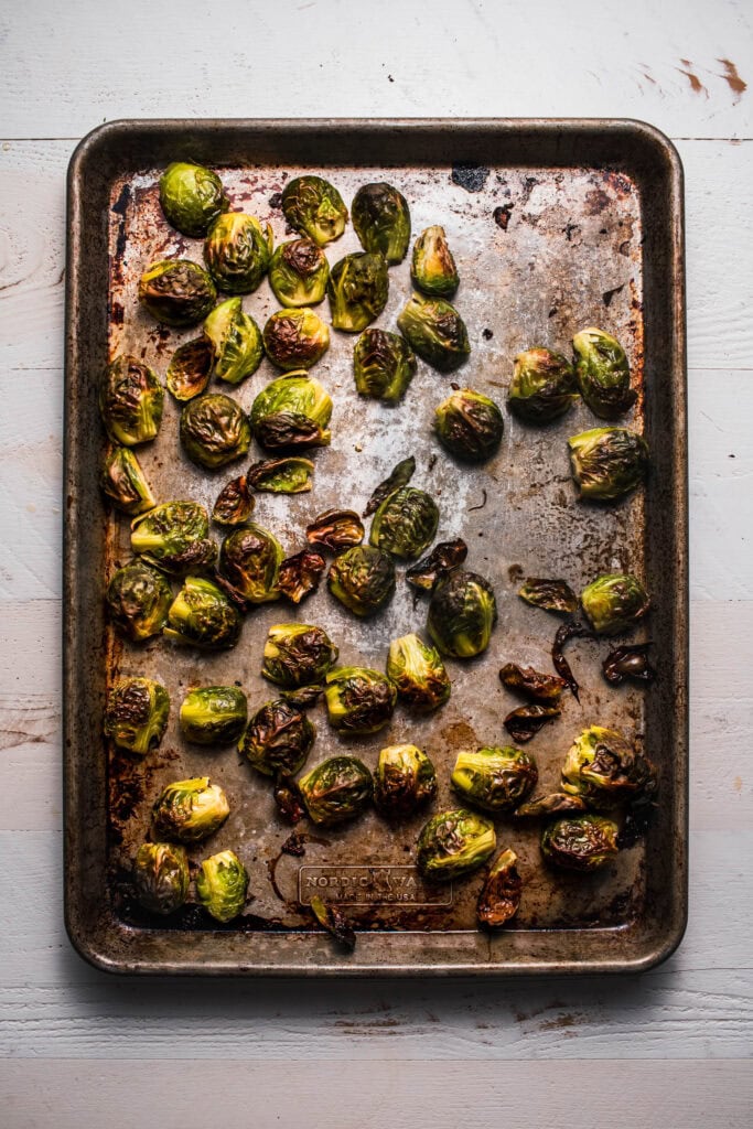 Roasted brussel sprouts on baking sheet. 