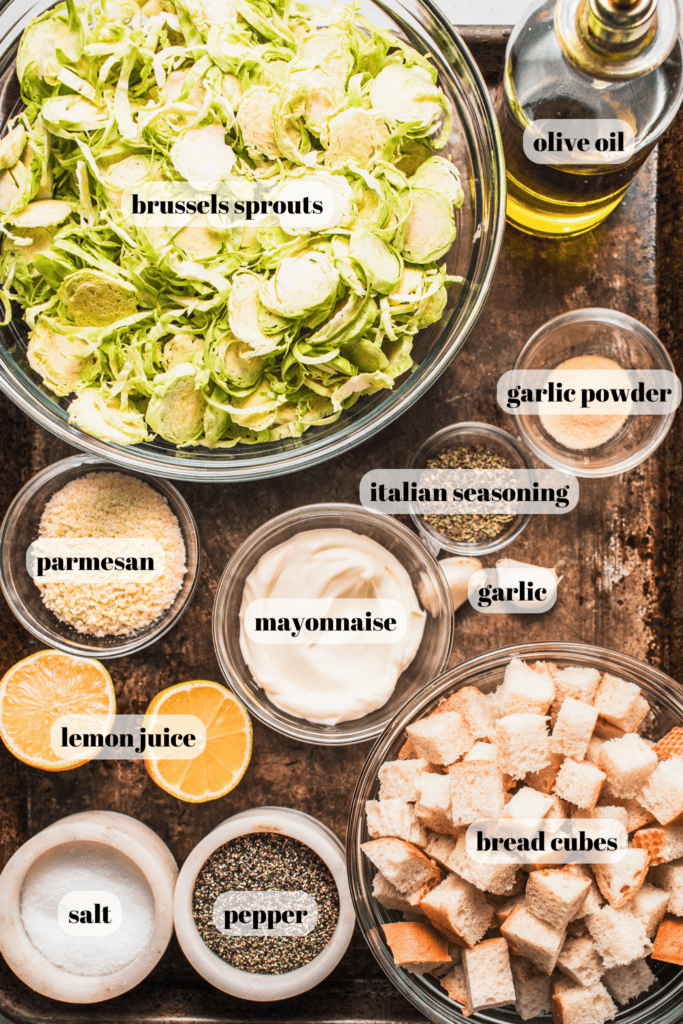 Ingredients for brussels sprouts caesar salad on tray.