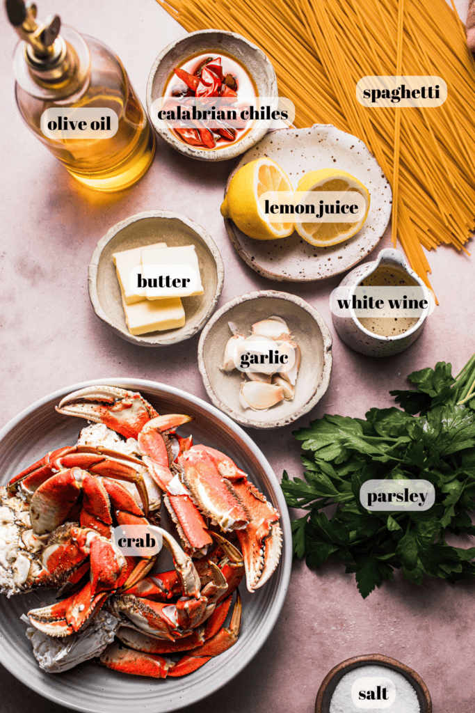 Ingredients for crab pasta labeled on counter.