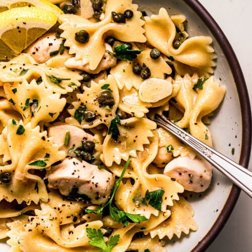 Close up of chicken piccata pasta in serving bowl.