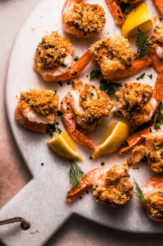 Close up of crab stuffed shrimp on serving plate.